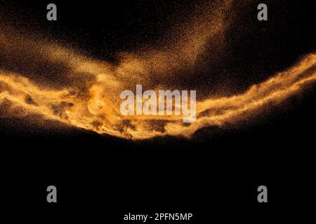 Brown colored sand splash.Dry river sand explosion isolated on black background. Stock Photo
