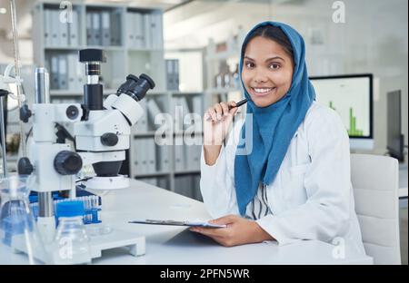 Every day I spend here makes a difference. Portrait of a young scientist conducting research in a laboratory. Stock Photo