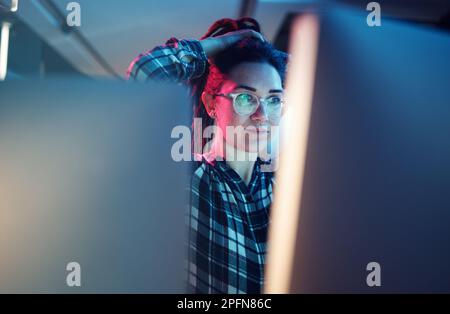 Cybersecurity, malware and woman hacker working on a computer in the basement at night for phishing. Database, password and ransomware with a female Stock Photo