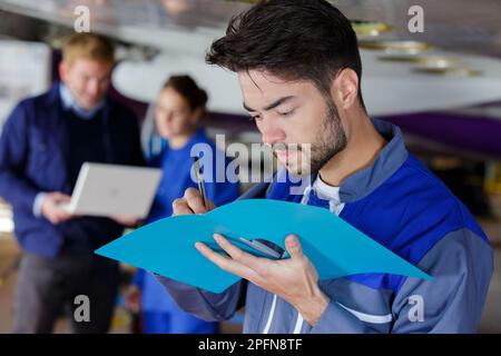 airplane engineer taking notes on notepad Stock Photo