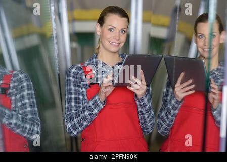 female worker using a tablet in factory Stock Photo