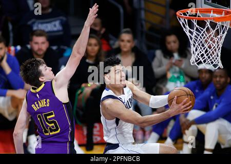 Los Angeles, United States. 17th Mar, 2023. Dallas Mavericks guard Josh Green (R) goes to the basket under pressure from Los Angeles Lakers guard Austin Reaves (L) during an NBA basketball game at Crypto.com Arena in Los Angeles. Credit: SOPA Images Limited/Alamy Live News Stock Photo