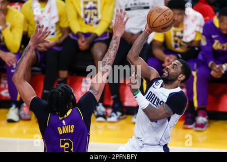 Los Angeles, United States. 17th Mar, 2023. Dallas Mavericks guard Kyrie Irving (R) shoots against Los Angeles Lakers forward Anthony Davis (L) during an NBA basketball game at Crypto.com Arena in Los Angeles. Credit: SOPA Images Limited/Alamy Live News Stock Photo
