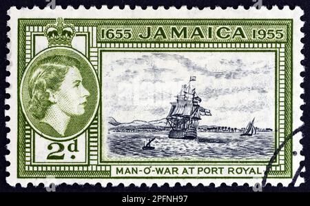 JAMAICA - CIRCA 1955: A stamp printed in Jamaica shows H.M.S. Britannia at Port Royal and Queen Elizabeth II, circa 1955. Stock Photo
