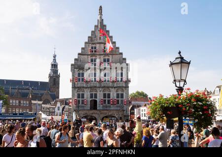 Cheese market in the Dutch city of Gouda with a view of the old town hall and the Sint Janskerk. Stock Photo