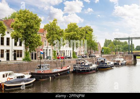 Old harbor in Den Bosch, with boats and medieval canal houses. Stock Photo