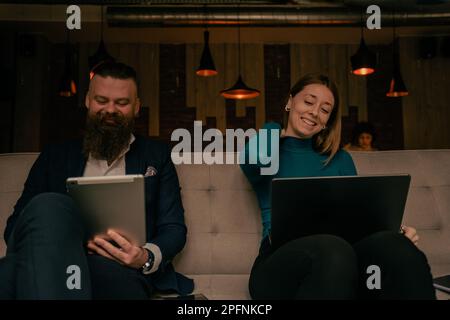 Beautiful business partners having fun conversation while working together at the cafeteria Stock Photo