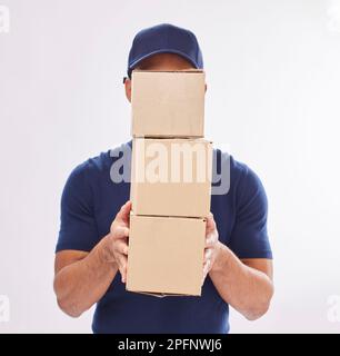 Delivery guy package, shipping boxes and export employee in studio with courier service. Box, supply chain and parcel logistics of a worker with Stock Photo