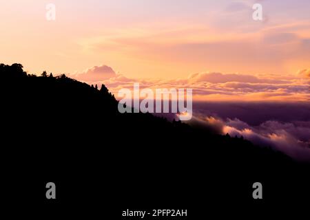 Scenic early morning view of the clouds covered over the valley and mountains near Kinabalu National Park, Sabah, Malaysia Stock Photo