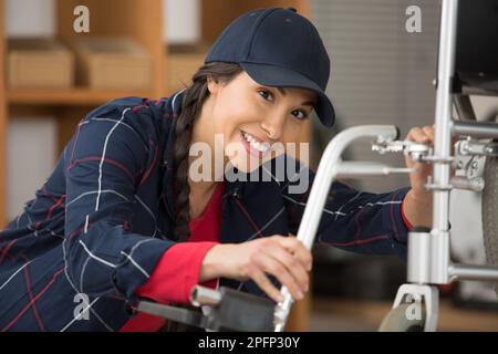 a female plumber working on central heating boiler Stock Photo