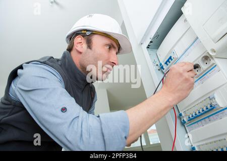 electrician testing the panel outlet Stock Photo