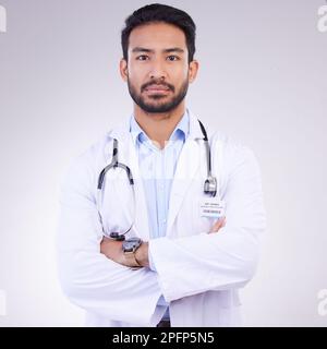 Proud portrait of man or doctor isolated on a white background for healthcare services, leadership and career mindset. Serious face of medical Stock Photo