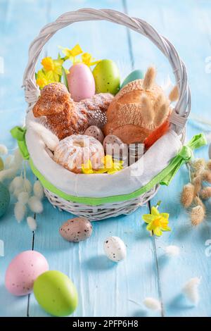Festive Easter basket as Traditions on Holy Sunday in Easter. Cake, catkins and Easter eggs for Easter. Stock Photo