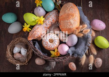 Colorful Easter basket as Traditions on Holy Sunday in Easter. Cake, catkins and Easter eggs for Easter. Stock Photo