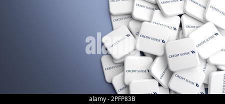 Logos of Credit Suisse Bank on a heap on a table. Copy space. Web banner format. Stock Photo