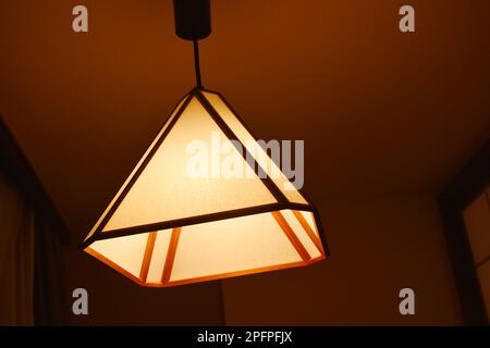 Japanese electric lamp hanging on ceiling room in the night Stock Photo