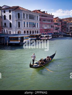 A couple enjoys the view of Venice’s Grand Canal from a gondola. Stock Photo