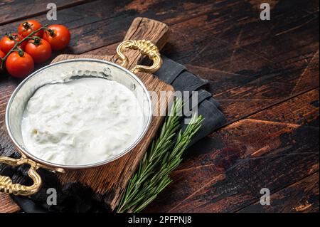Straciatella fresh italian creamy cheese. Wooden background. Top view. Copy space. Stock Photo