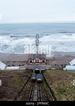 An aerial view of the Saltburn By The Sea Funicular cliff lift transporting tourists from the pier and beach Stock Photo