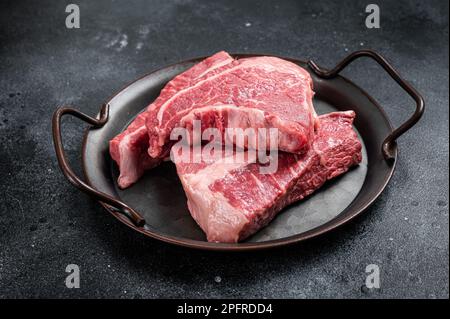 Raw Silverside sirloin beef steak cut on butcher tray. Black background. Top view. Stock Photo