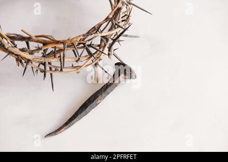 Crucifixion Of Jesus Christ. Cross With three Nails And Crown Of Thorns on  ground Stock Photo | Adobe Stock