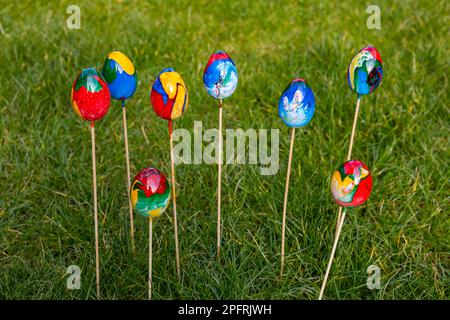 Marbled colored colorful easter eggs isolated with selective focus in the garden Stock Photo