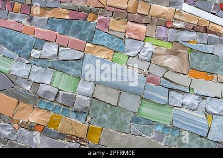 Mosaic panel from pieces of ceramic tiles, marble and granite. Abstract mosaic colored ceramic stones. Stock Photo