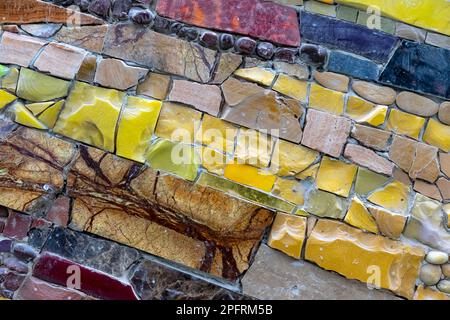 Mosaic of colored tiles and natural stones. Ceramic mosaic background. Stock Photo