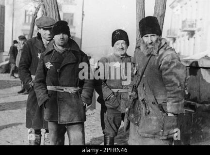 In the early stages of WW2 the Jews in nazi occupied europe were rounded up and forced into crowded ghettoes. When the decision was made to kill them all they were deported to extermination centres to be murdered. This image show Jewish men forced to wear the yellow star in the Lublin Ghetto. Stock Photo