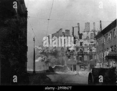 In January 1943 the nazis arrived to round up the Jews of the Warsaw Ghetto  The Jews, resolved to fight it out, took on the SS with homemade and primitive weapons. The defenders were executed or deported and the Ghetto area was systematically demolished. This event is known as The Ghetto Uprising. This image shows the city in various stages of its destruction. This image is from the German photographic record of the event, known as the Stroop report. Stock Photo