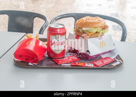 Lisbon, Portugal - December 3, 2022: McDonald's meal with french fries, CBO burger and Sagres beer. Stock Photo