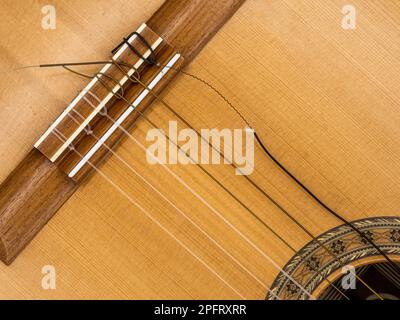 A broken guitar string can be frustrating, but is easy to fix. Stock Photo