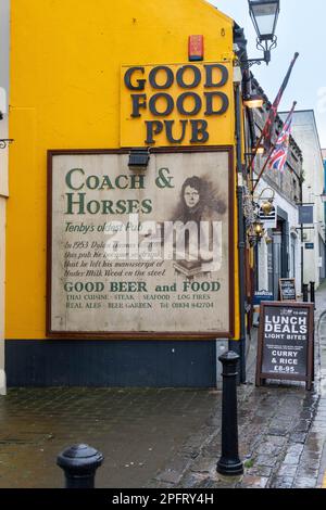 Sign on wall in Tenby stating Historic coach and horses pub where Dylan Thomas is reputed to have left the manuscript of under milk wood on the stool Stock Photo