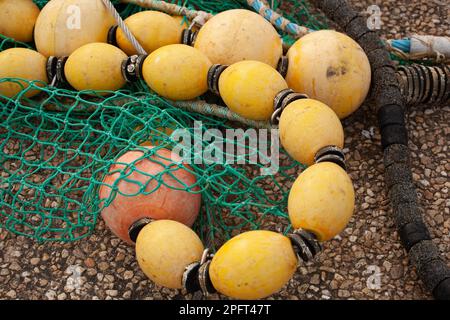 Fishing net and trap as a decoration on a red wooden wall Stock