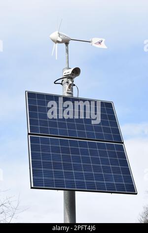 A  surveillance camera in a car park powered by solar and wind power. Stock Photo