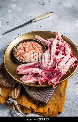 Fresh Raw Duck Tongue ready for cooking. Gray background. Top view. Stock Photo