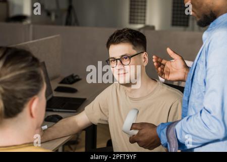 Programmers working in the office of a software development company. Coding technologies, site design. Successful diverse Teamwork. Cyberspace concept Stock Photo