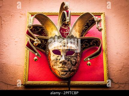 Traditional Venetian Mask on old wall background Stock Photo