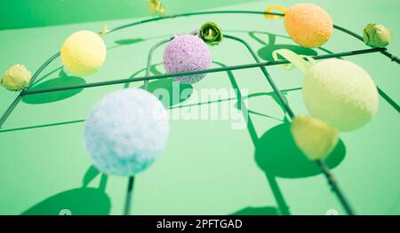 Hanging easter colorful eggs with a shadow on a green background Stock Photo