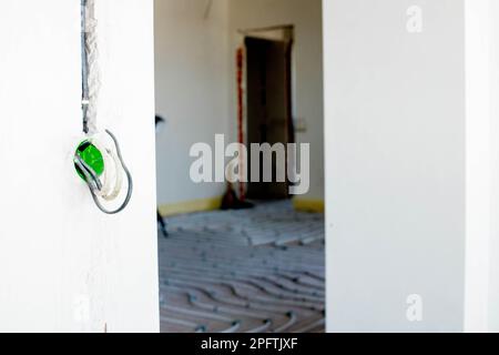 New wiring in plastic box and electrical cables for future wall sockets, repair concept. Electrical wiring Stock Photo