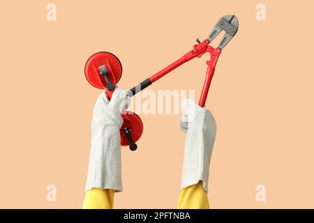Female worker with tools on beige background Stock Photo