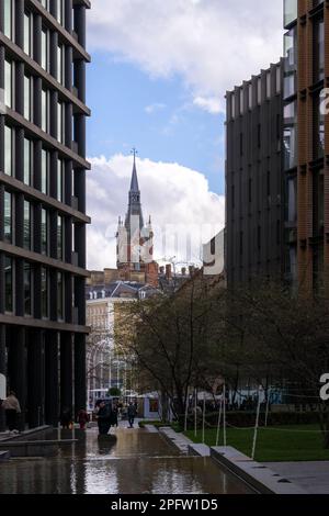 LONDON, ENGLAND - MARCH 17th, 2023: St Pancras tower framed by modern buildings Stock Photo