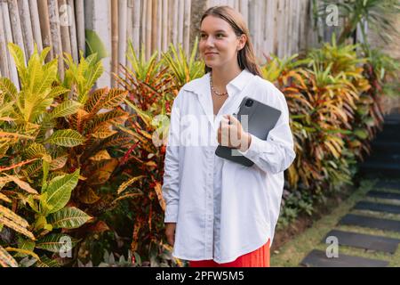 Attractive woman freelancer with digital tablet in outdoor Stock Photo