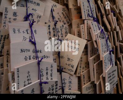Ema, small wooden plaques on which Shinto and Buddhist worshippers write prayers or wishes - Wooden Message or Prayer Boards - Kyoto, Japan Stock Photo