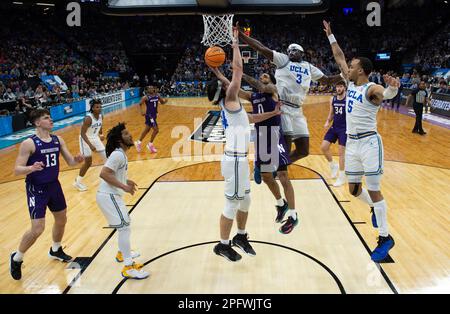 Sacramento, CA, USA. 18th Mar, 2023. UCLA Bruins forward Kenneth Nwuba (14) and UCLA Bruins forward Adem Bona (3) defend against basket by Northwestern Wildcats guard Boo Buie (0) during a game in the NCAA Tournament at Golden 1 Center in Sacramento, Saturday, March 18, 2023. Princeton Tigers beat the Missouri Tigers 78-63. (Credit Image: © Paul Kitagaki Jr./ZUMA Press Wire) EDITORIAL USAGE ONLY! Not for Commercial USAGE! Stock Photo