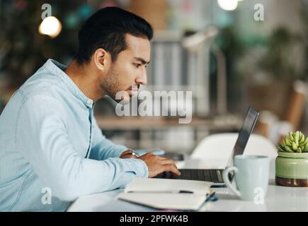 Business, focus and man with laptop, research and online reading in workplace, software update or website design. Male employee, consultant or worker Stock Photo