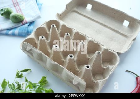 egg carton without eggs on table , Stock Photo