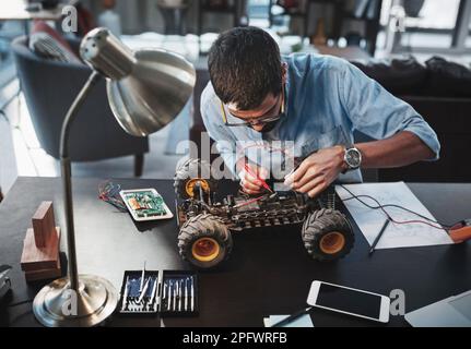 Working on his latest invention. a young engineer working from home. Stock Photo
