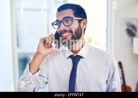 Its always good to hear from a happy client. a young man using a laptop to make a video call while working from home. Stock Photo