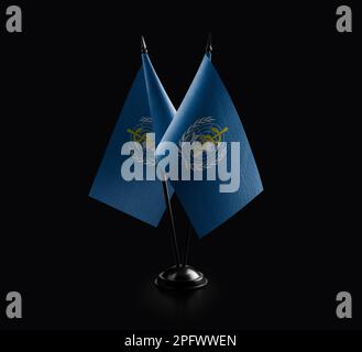 Small national flags of the World Health Organization WHO on a black ...